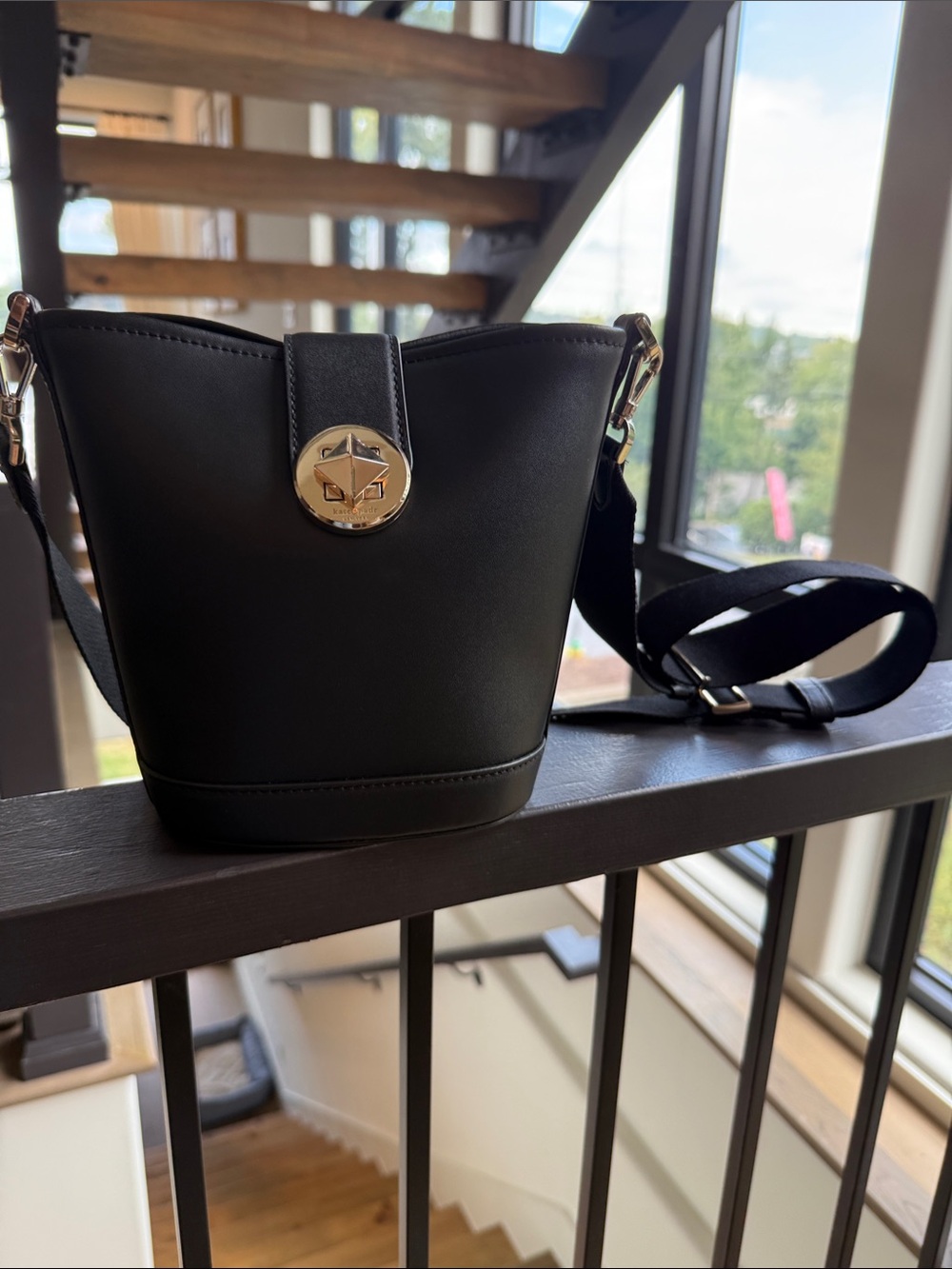 Structured Black Crossbody Bucket Bag with Gold Accent